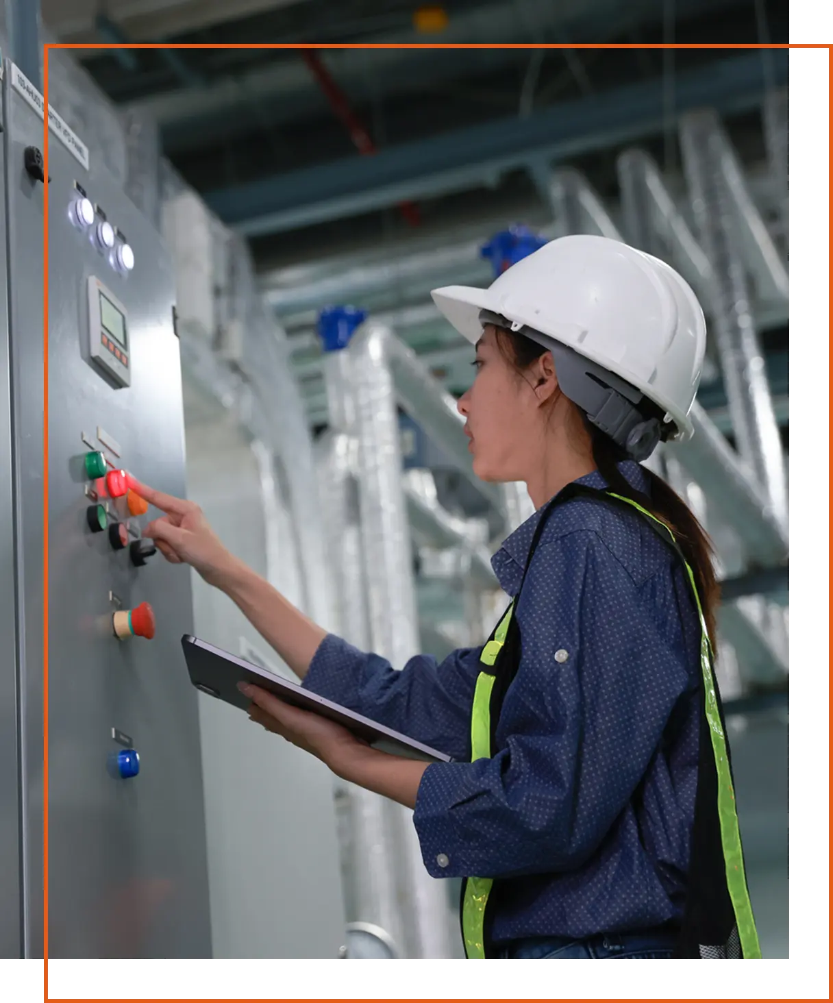 Engineer operating control panel in industrial setting.